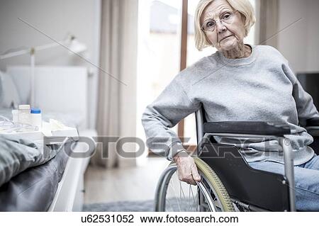 Senior woman in wheelchair in care home. View Large Photo Image Stock Image - Senior woman in wheelchair in care home.. Fotosearch