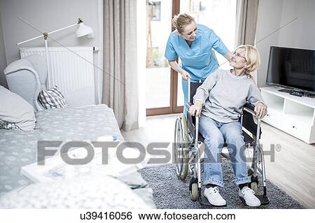 Senior woman in wheelchair with care worker in care home. View Large Photo Image Stock Photograph - Senior woman in wheelchair with care worker in care home.. Fotosearch