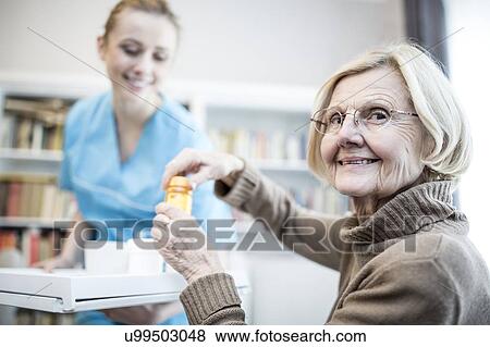 Senior woman opening medicine bottle and smiling. View Large Photo Image Stock Photo - Senior woman opening medicine bottle and smiling.. Fotosearch