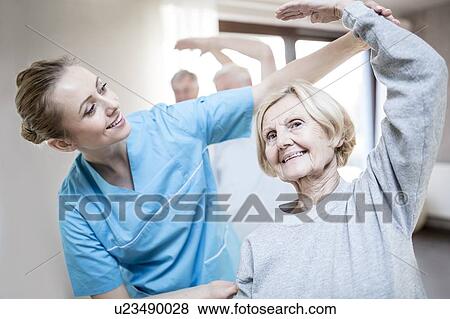 Senior woman stretching, physiotherapist helping. View Large Photo Image Stock Photo - Senior woman stretching, physiotherapist helping.. Fotosearch
