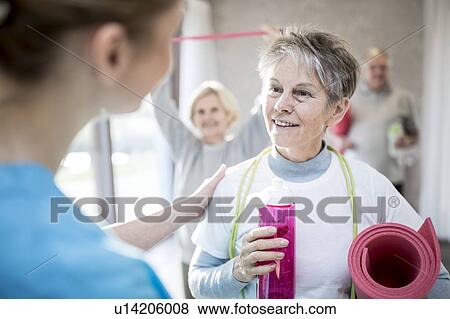 Senior woman talking to physiotherapist. View Large Photo Image Stock Photo - Senior woman talking to physiotherapist.. Fotosearch