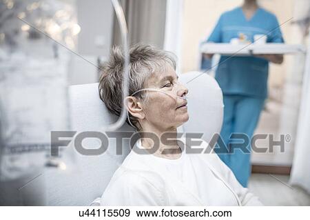 Stock Photo - Senior woman with nasal cannula and IV bag.. Fotosearch