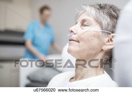 Stock Image - Senior woman with nasal cannula.. Fotosearch