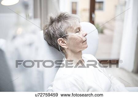Stock Photo - Senior woman with nasal cannula.. Fotosearch