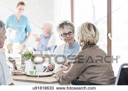 Stock Image - Senior women talking in care home.. Fotosearch