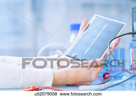 Solar battery research. Researcher holding a silicon photovoltaic element. View Large Photo Image Stock Photo - Solar battery research. Researcher holding a silicon photovoltaic element.. Fotosearch