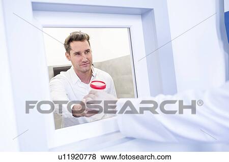 Sperm sample being handled in a fertility clinic. View Large Photo Image Stock Photo - Sperm sample being handled in a fertility clinic.. Fotosearch