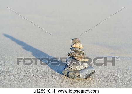 Stock Image - Stacked stones on a beach.. Fotosearch