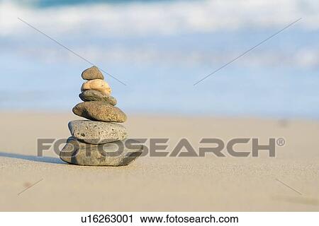 Stock Image - Stacked stones on a beach.. Fotosearch