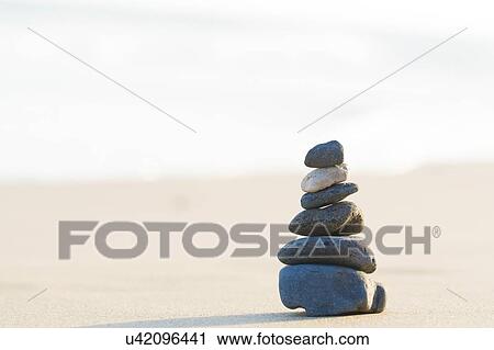 Stacked stones on a beach. View Large Photo Image Stock Image - Stacked stones on a beach.. Fotosearch