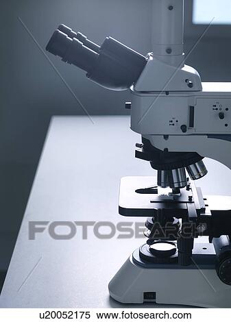 Stock Photography - Still life of a microscope on a laboratory bench to illustrate research.. Fotosearch