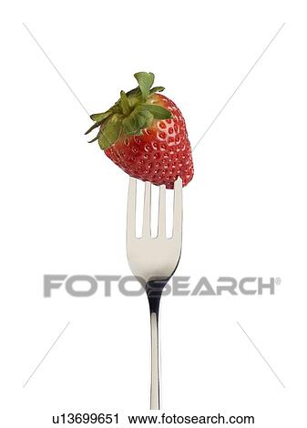 Stock Image - Strawberry on a fork.. Fotosearch