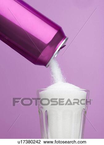 Stock Image - Sugar pouring from a drinks can into a glass.. Fotosearch