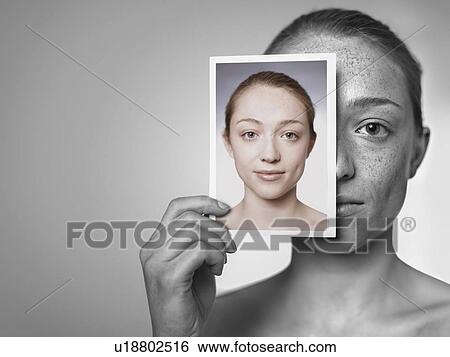 Stock Photograph - Sun damage. Woman showing the damage sun exposure has done to her skin.. Fotosearch