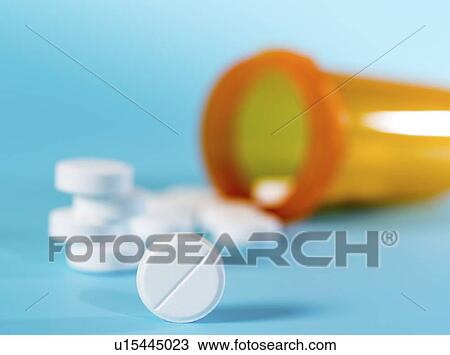 Stock Image - Tablets spilling from container.. Fotosearch