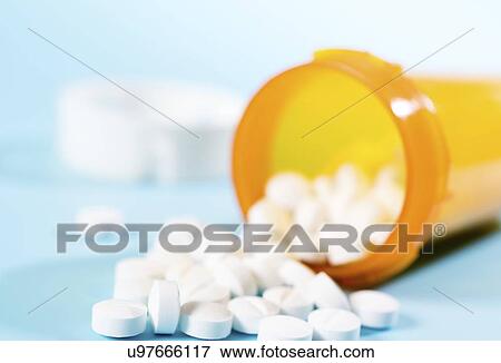 Stock Photo - Tablets spilling from container.. Fotosearch