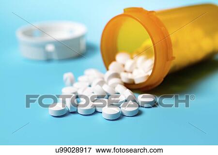 Stock Photo - Tablets spilling from container.. Fotosearch