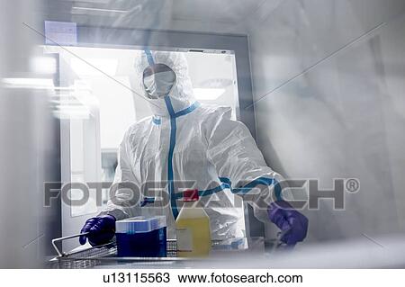 Technician collecting equipment from a transfer hatch in a sterile laboratory that manufactures human tissues for implants. Such implants include bone and skin grafts. View Large Photo Image Stock Image - Technician collecting equipment from a transfer hatch in a sterile laboratory that manufactures human tissues for implants. Such implants include bone and skin grafts.. Fotosearch