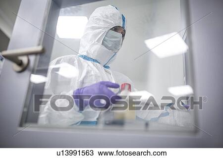 Technician collecting equipment from a transfer hatch in a sterile laboratory that manufactures human tissues for implants. Such implants include bone and skin grafts. View Large Photo Image Stock Image - Technician collecting equipment from a transfer hatch in a sterile laboratory that manufactures human tissues for implants. Such implants include bone and skin grafts.. Fotosearch