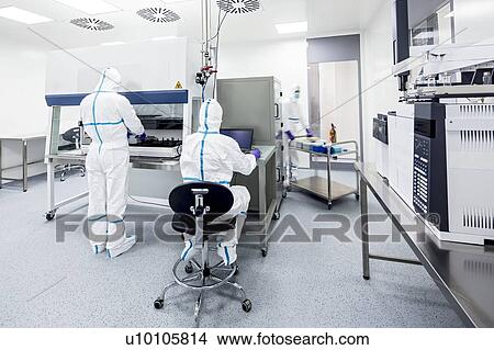 Picture - Technicians preparing and checking samples in a laboratory that manufactures human tissues for implant. Such tissues include bone and skin grafts.. Fotosearch