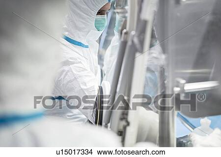 Picture - Technicians working in sealed, sterile isolator units in a laboratory that manufactures human tissues for implant. Such tissues include bone and skin grafts.. Fotosearch