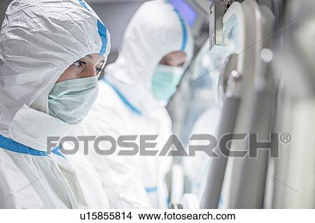 Technicians working in sealed, sterile isolator units in a laboratory that manufactures human tissues for implant. Such tissues include bone and skin grafts. View Large Photo Image Picture - Technicians working in sealed, sterile isolator units in a laboratory that manufactures human tissues for implant. Such tissues include bone and skin grafts.. Fotosearch