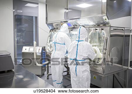 Picture - Technicians working in sealed, sterile isolator units in a laboratory that manufactures human tissues for implant. Such tissues include bone and skin grafts.. Fotosearch