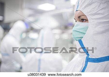 Technicians working in sealed, sterile isolator units in a laboratory that manufactures human tissues for implant. Such tissues include bone and skin grafts. View Large Photo Image Stock Photo - Technicians working in sealed, sterile isolator units in a laboratory that manufactures human tissues for implant. Such tissues include bone and skin grafts.. Fotosearch
