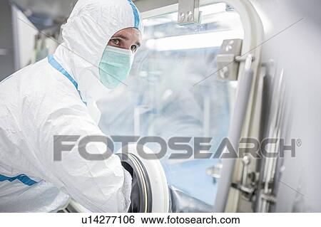 Technicians working in sealed, sterile isolator units in a laboratory that manufactures human tissues for implant. Such tissues include bone and skin grafts. View Large Photo Image Stock Photograph - Technicians working in sealed, sterile isolator units in a laboratory that manufactures human tissues for implant. Such tissues include bone and skin grafts.. Fotosearch