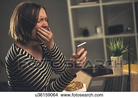 Picture - Tired woman multitasking.. Fotosearch