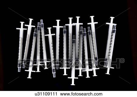 Stock Image - Tuberculin syringes on black background.. Fotosearch