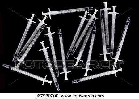 Stock Image - Tuberculin syringes on black background.. Fotosearch