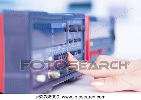 Stock Image - Using electronic test equipment.. Fotosearch