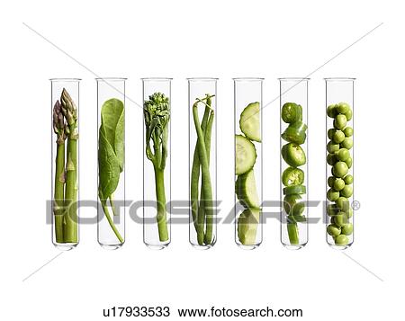 Stock Image - Vegetables in test tubes, studio shot.. Fotosearch