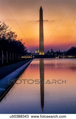 Stock Image - Washington Monument and reflecting pond at sunrise, Washington D. C.. Fotosearch