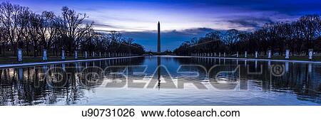 Stock Photograph - Washington Monument and reflecting pond at sunrise, Washington D. C.. Fotosearch