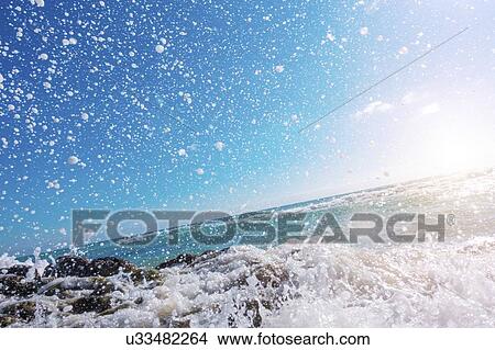 Waves breaking against rocks. View Large Photo Image Picture - Waves breaking against rocks.. Fotosearch