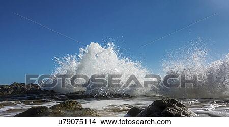 Waves breaking against rocks. View Large Photo Image Picture - Waves breaking against rocks.. Fotosearch