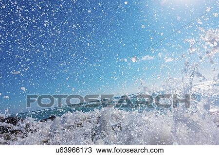 Waves breaking against rocks. View Large Photo Image Stock Image - Waves breaking against rocks.. Fotosearch