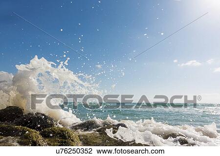 Waves breaking against rocks. View Large Photo Image Stock Image - Waves breaking against rocks.. Fotosearch