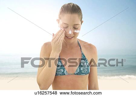 Woman applying sunscreen to her face. View Large Photo Image Stock Photo - Woman applying sunscreen to her face.. Fotosearch