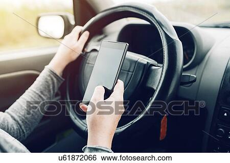 Woman driving and using smartphone. View Large Photo Image Stock Photograph - Woman driving and using smartphone.. Fotosearch