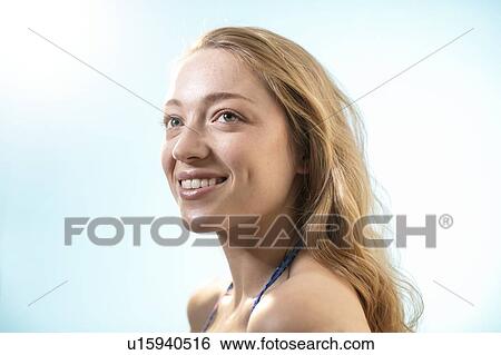 Stock Photograph - Woman in sunlight, smiling.. Fotosearch
