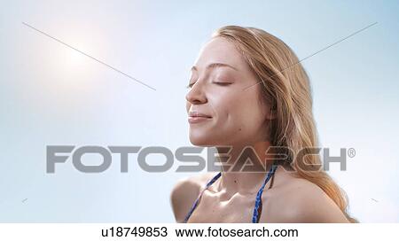 Woman in sunlight with eyes closed. View Large Photo Image Stock Image - Woman in sunlight with eyes closed.. Fotosearch