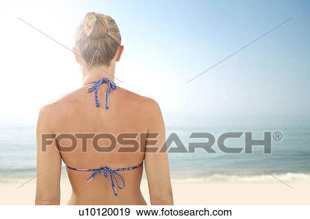 Stock Photo - Woman on beach, rear view.. Fotosearch