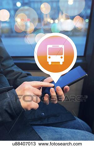 Stock Image - Woman using public transport app.. Fotosearch