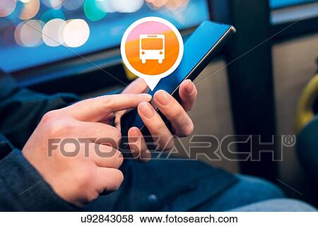 Stock Photo - Woman using public transport app.. Fotosearch