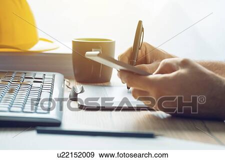Worker using pen tablet and mobile phone. View Large Photo Image Stock Photo - Worker using pen tablet and mobile phone.. Fotosearch