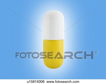 Stock Photograph - Yellow and white capsule, studio shot.. Fotosearch