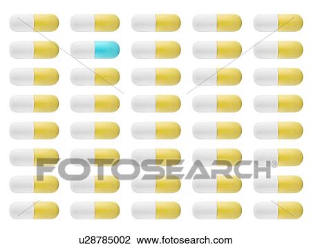 Stock Image - Yellow and white capsules and one blue and white capsule, studio shot.. Fotosearch
